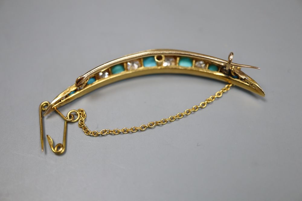 An Edwardian yellow metal, graduated turquoise and diamond set crescent brooch, 52mm, gross 5.3 grams.